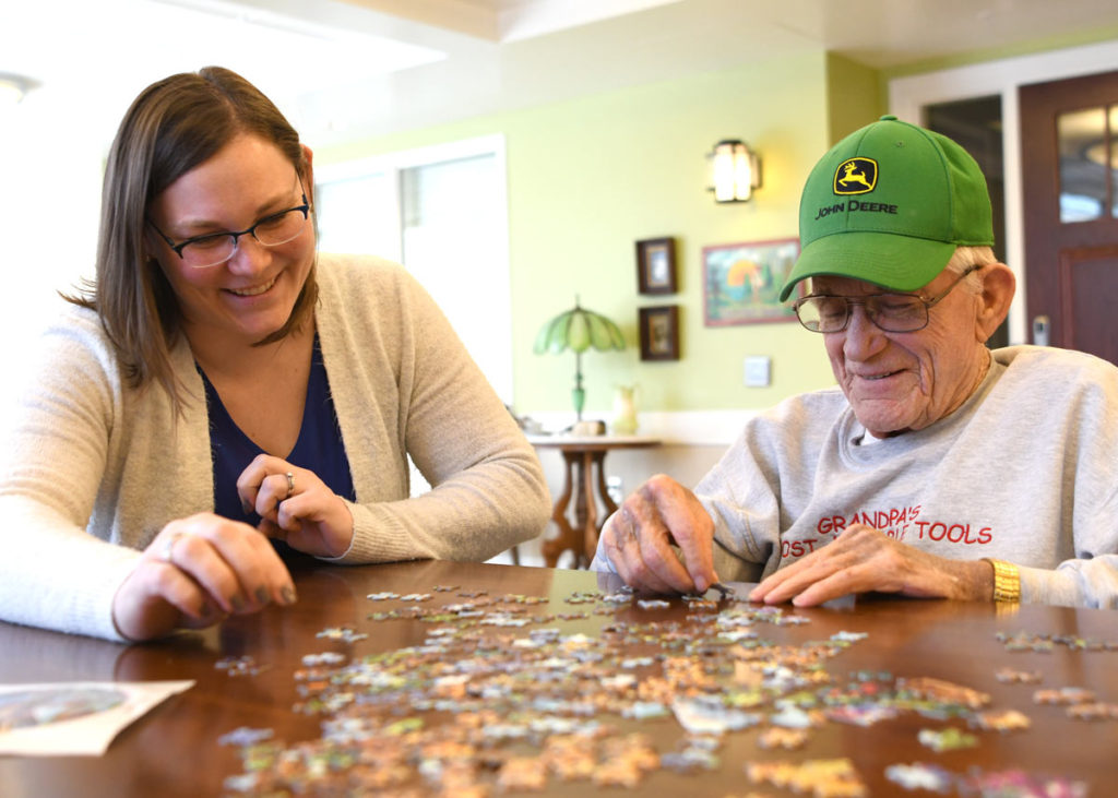 bethany life long term care resident completing a puzzle with nurse